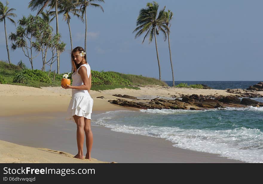 Young girl with coconut on the see side. Young girl with coconut on the see side