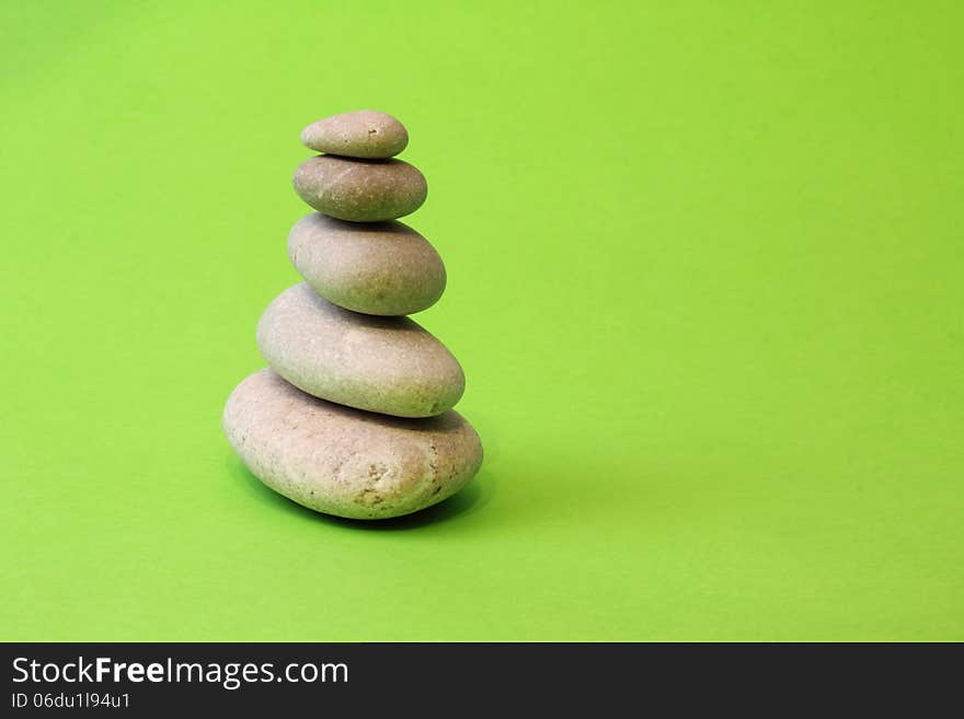 Pyramid of stones on a green background