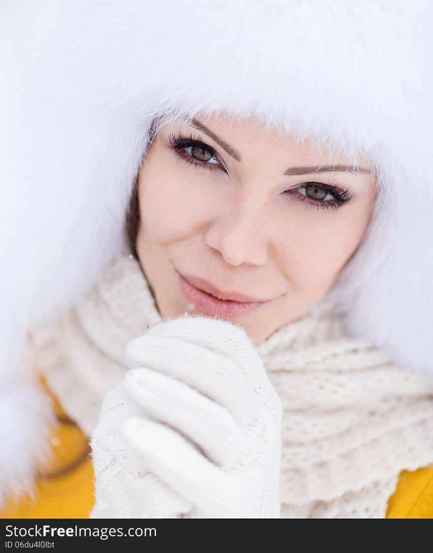 Winter Portrait Of Beautiful Smiling Woman With Snowflakes In White Furs