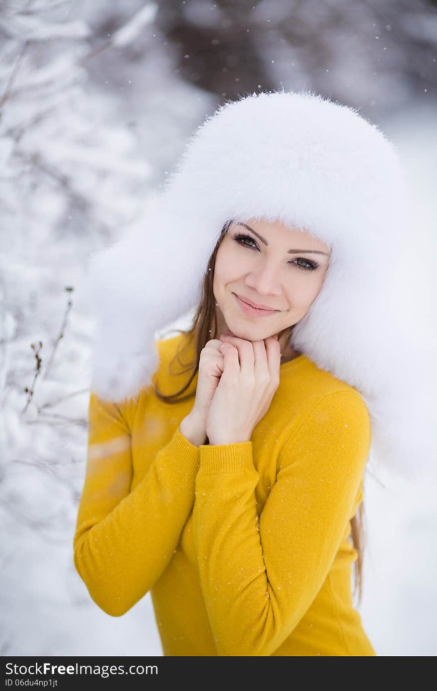 Winter Portrait Of Beautiful Smiling Woman With Snowflakes In White Furs