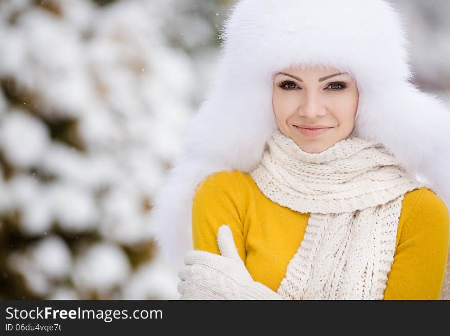 Winter Portrait Of Beautiful Smiling Woman With Snowflakes In White Furs