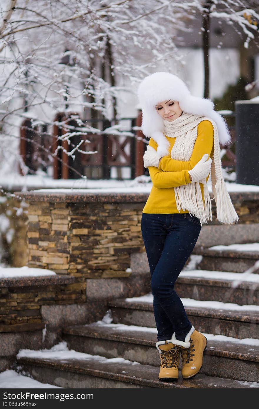 Winter Portrait Of Beautiful Smiling Woman With Snowflakes In White Furs