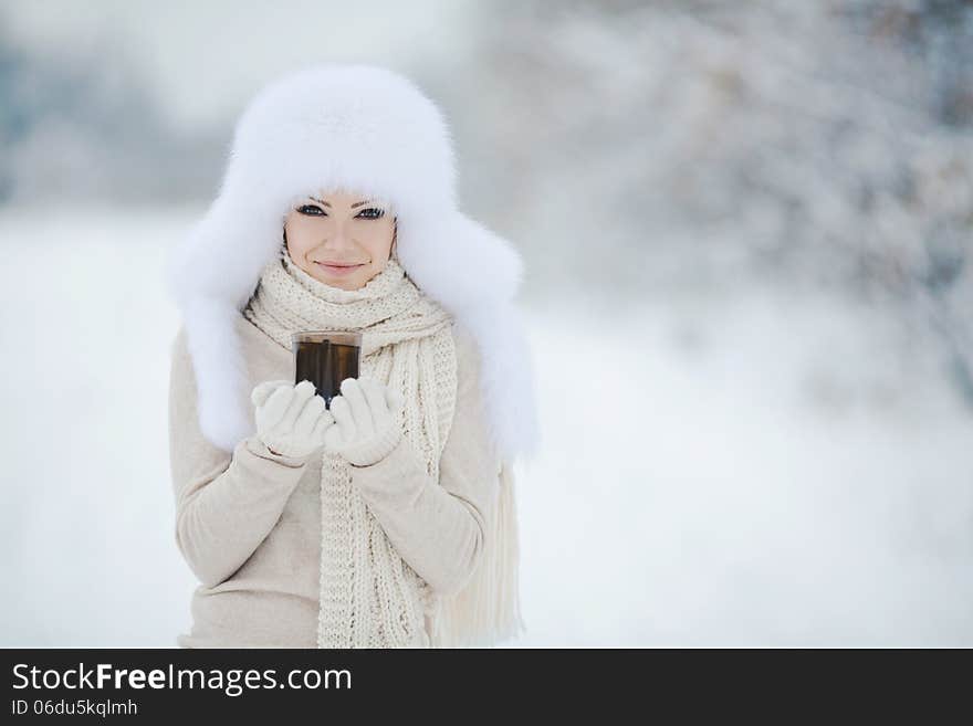 Winter Portrait Of Beautiful Smiling Woman With Snowflakes In White Furs