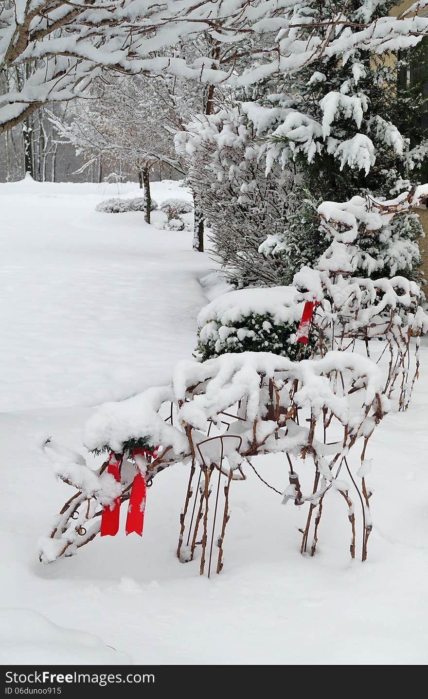 Christmas reindeer outdoor lawn decorations covered in snow after a winter storm. Christmas reindeer outdoor lawn decorations covered in snow after a winter storm.