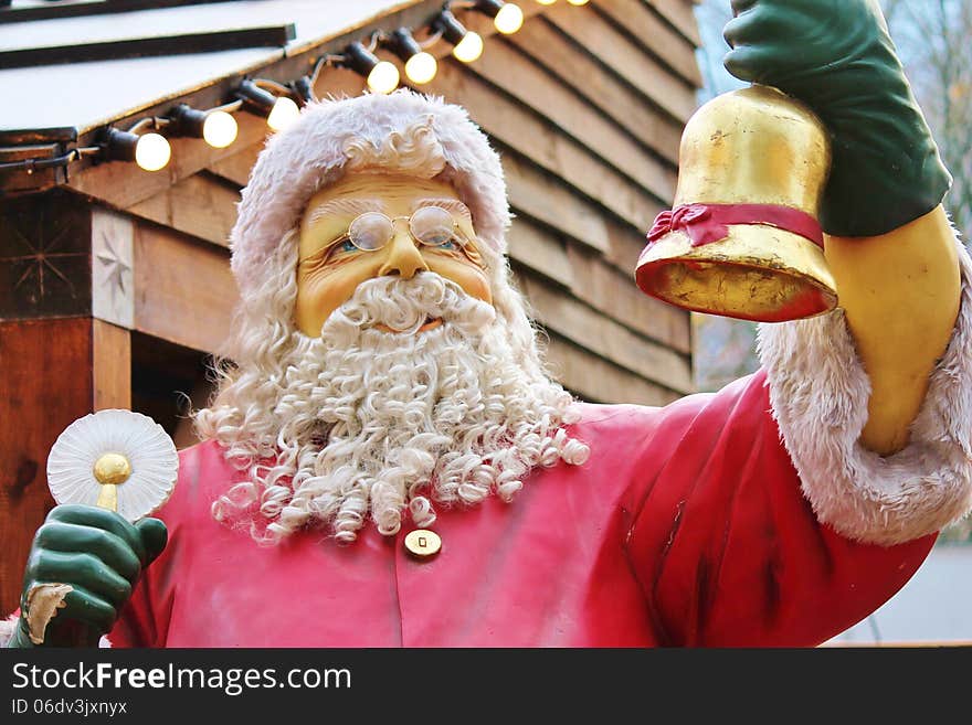 Statue of santa claus dressed in red with beard and hat