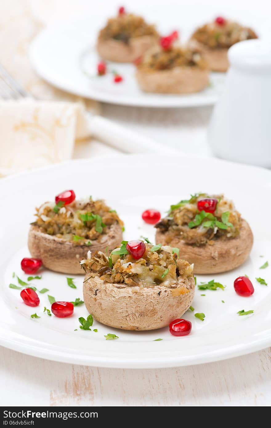 Appetizer - stuffed mushrooms with herbs and pomegranate seeds