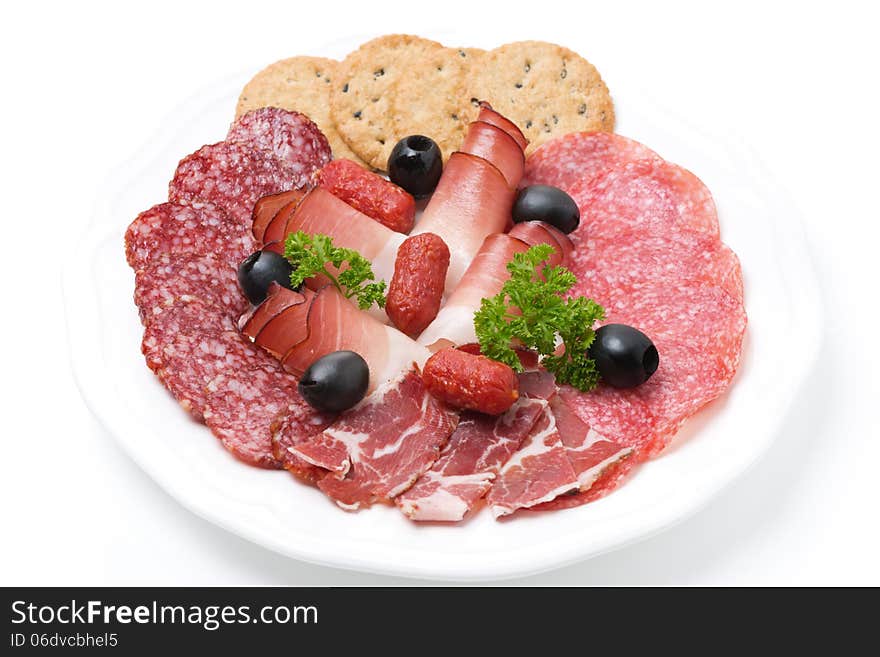 Assorted deli meats on a plate, isolated on white