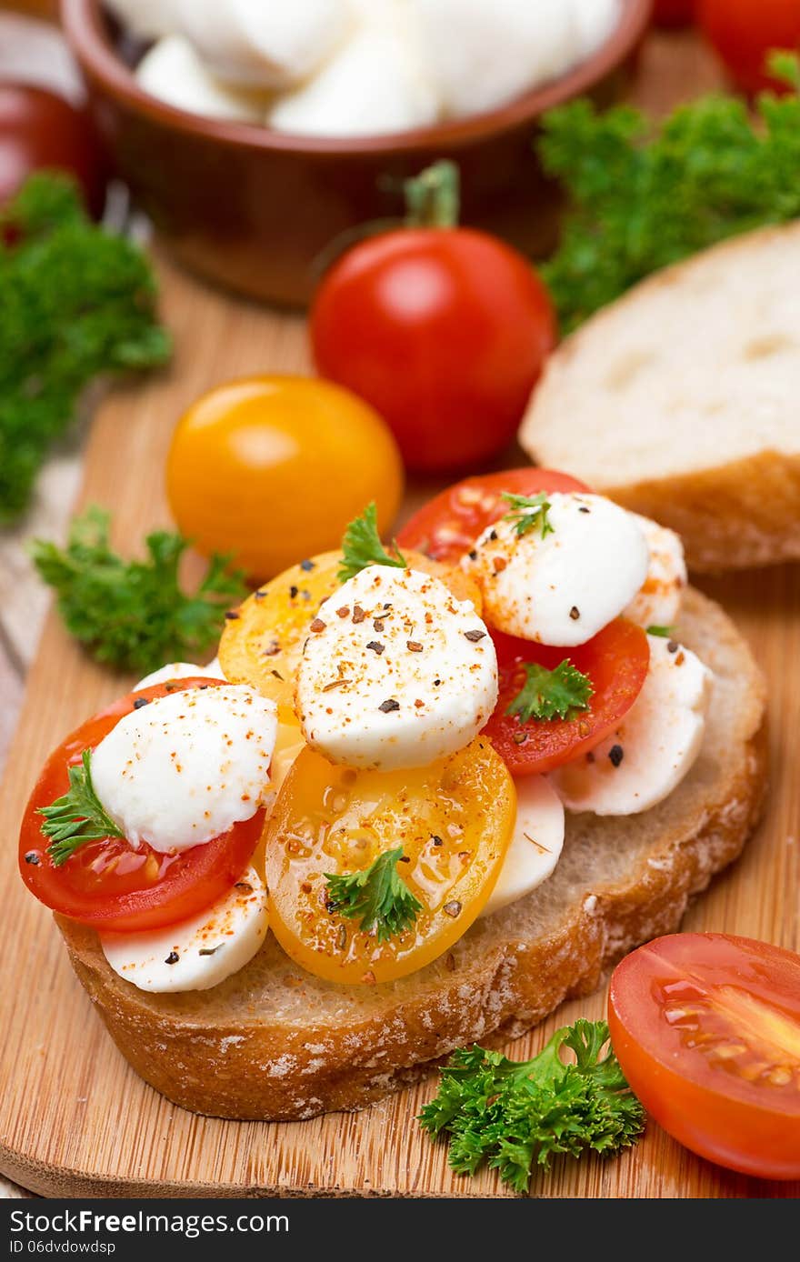 Ciabatta with mozzarella and colorful cherry tomatoes, close-up, vertical