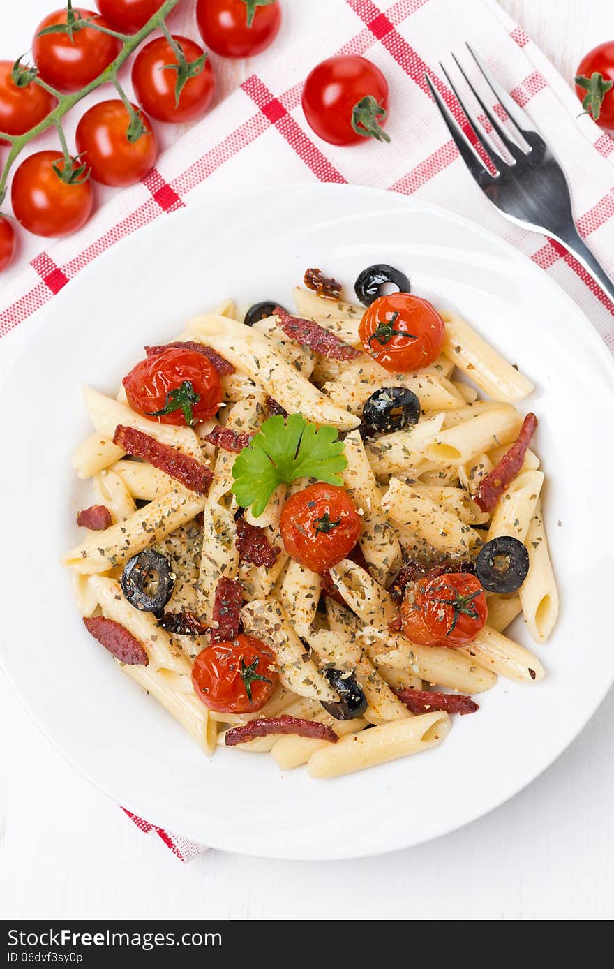 Pasta with sausage, tomatoes and olives, top view