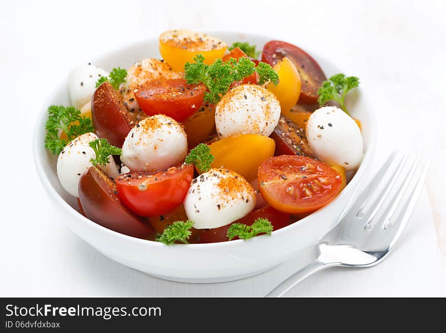 Salad with mozzarella and colorful cherry tomatoes, close-up