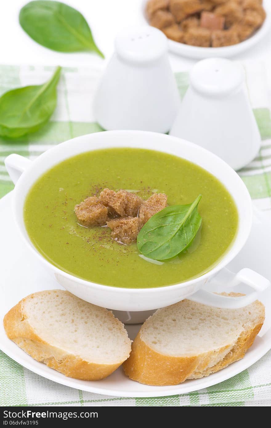 Spinach soup with croutons in a bowl