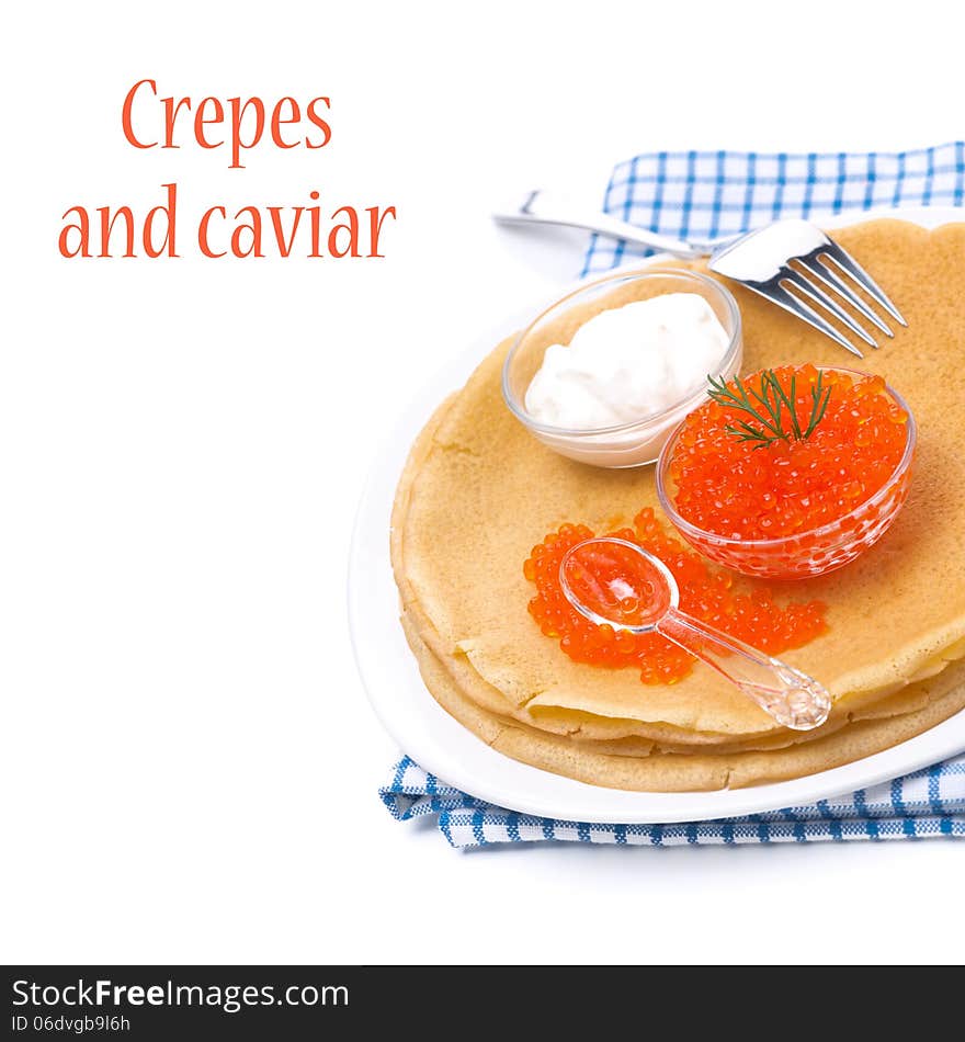 Traditional crepes with red caviar and sour cream on the plate, isolated on white