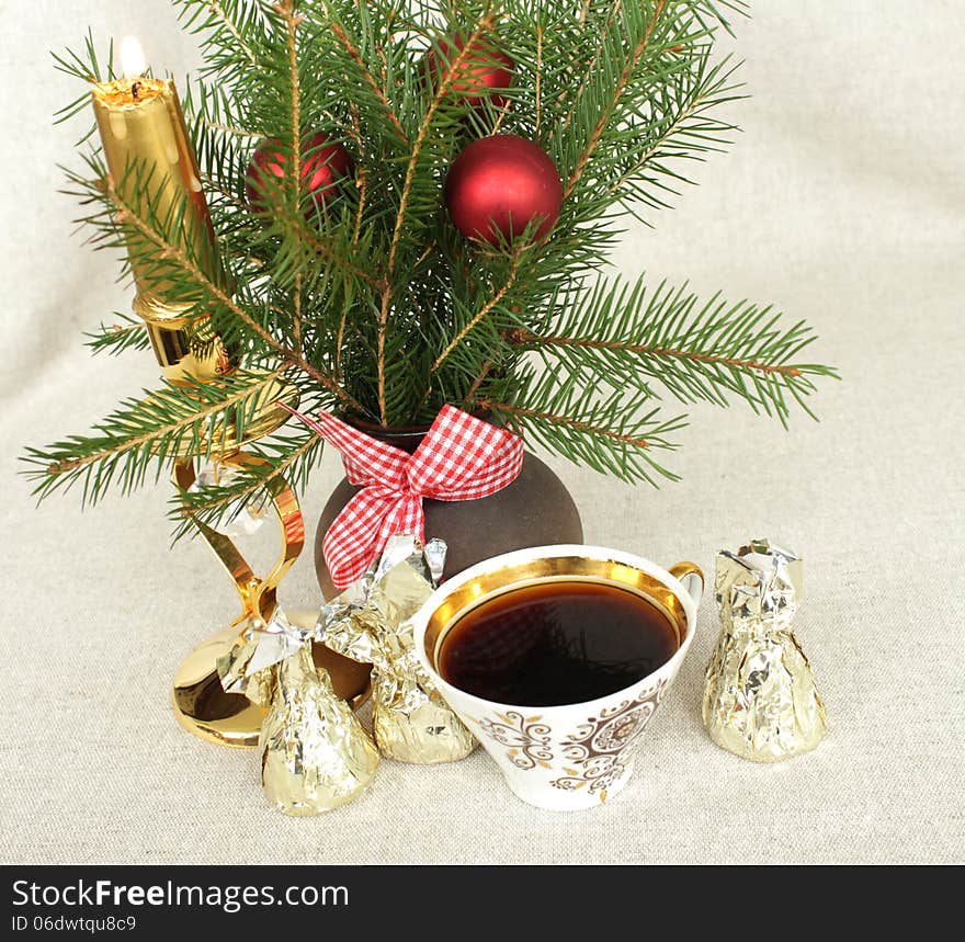 Christmas bouquet with a candle and a cup of coffee