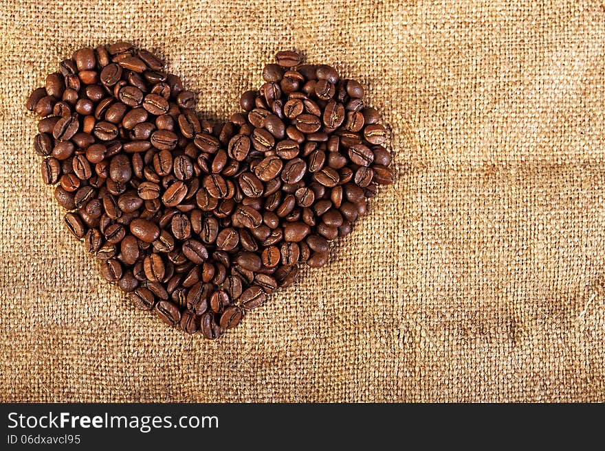 Background in the form of heart from fried coffee beans