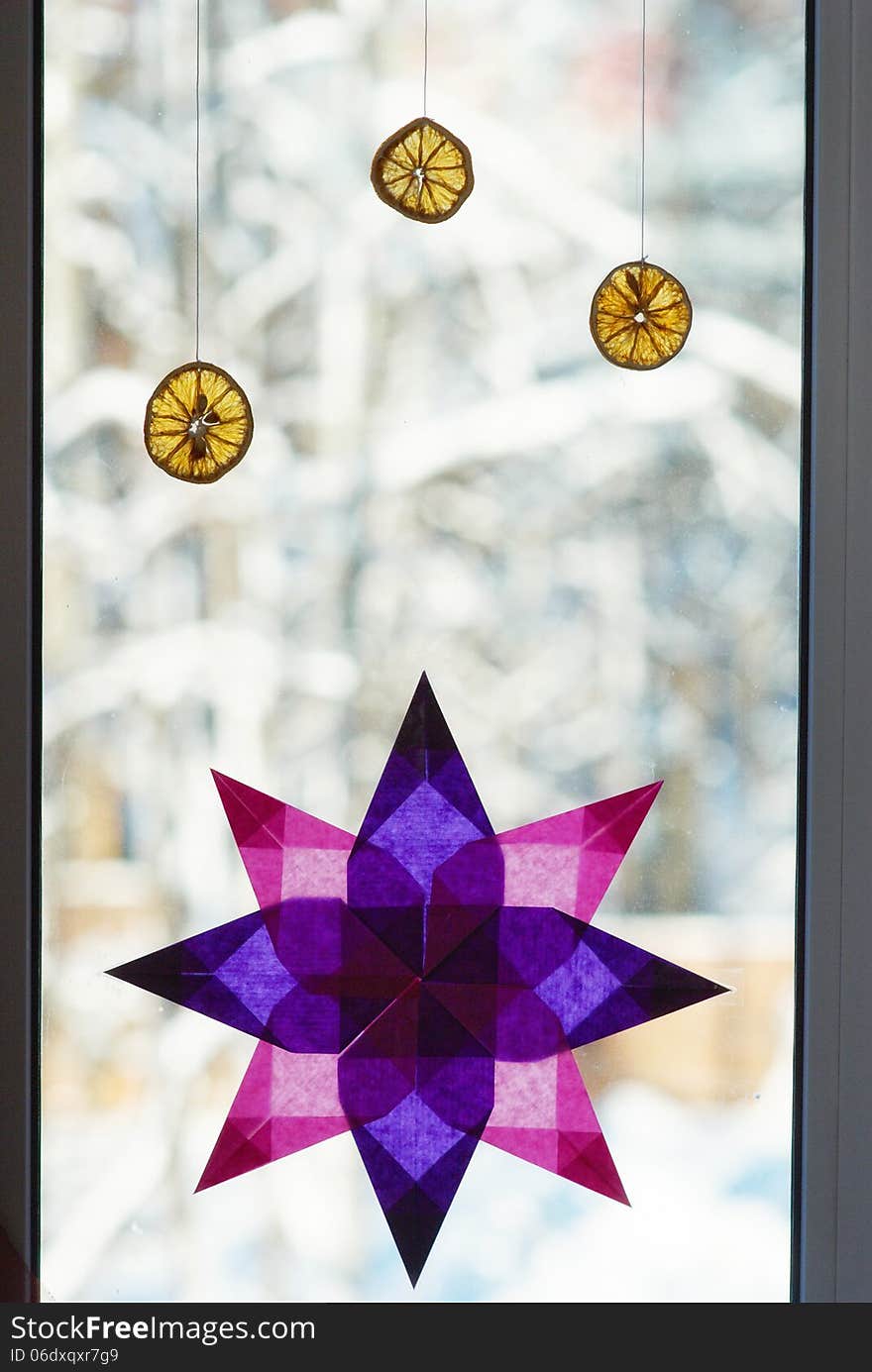 Window decorated with paper star and dried oranges. Window decorated with paper star and dried oranges