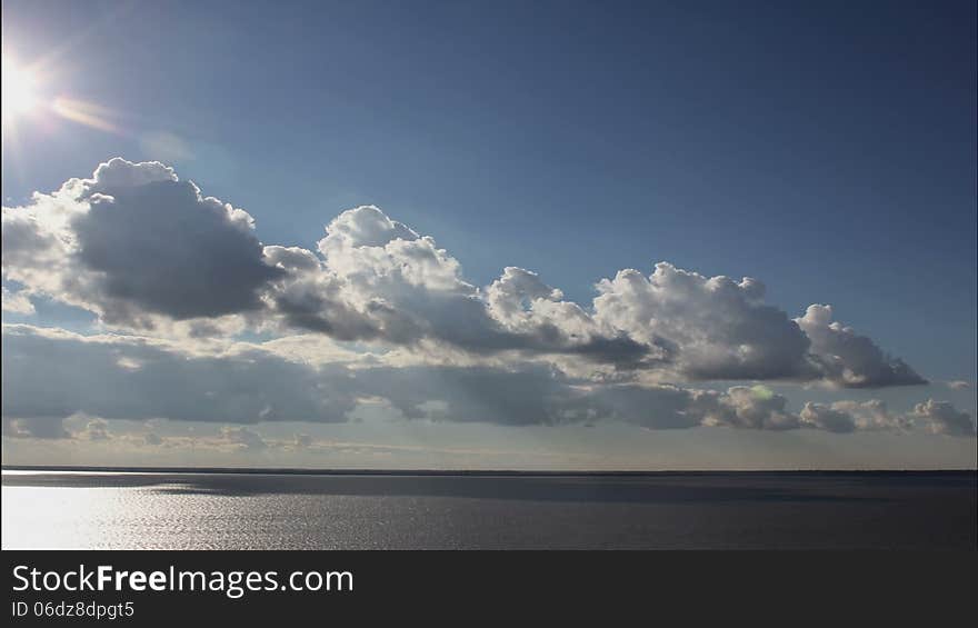 Drifting Cloud, cloud formation of different cloud types in a blue sky, at dusk, time lapse. Drifting Cloud, cloud formation of different cloud types in a blue sky, at dusk, time lapse