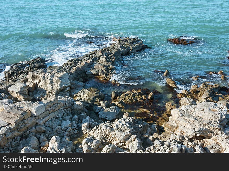 Ukraine, peninsula of Crimea, Sea coast on the Black Sea, large and small pebbles, large boulders, sea waves. Ukraine, peninsula of Crimea, Sea coast on the Black Sea, large and small pebbles, large boulders, sea waves