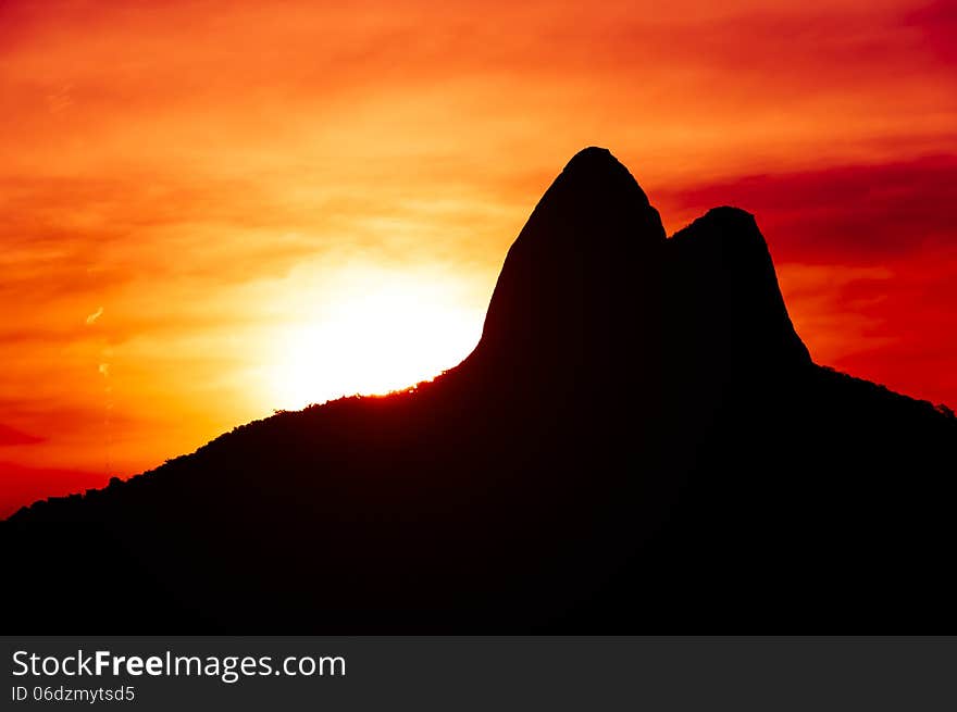 Beautiful Red Sunset Behind Mountains in Ipanema Beach, Rio de Janeiro, Brazil.