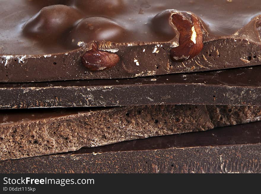 A closeup of pieces of chocolate (dark, milk).