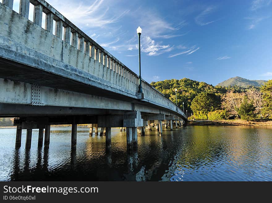 Concrete bridge with light pole over river