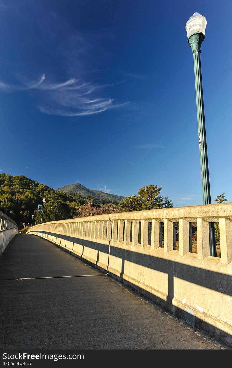 Concrete bridge with light pole over river