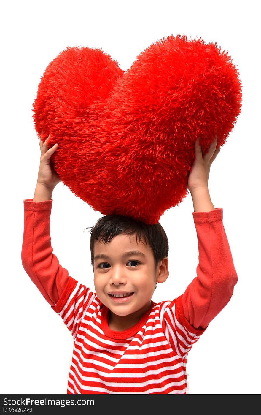 Little boy hold pillow red heart on white background