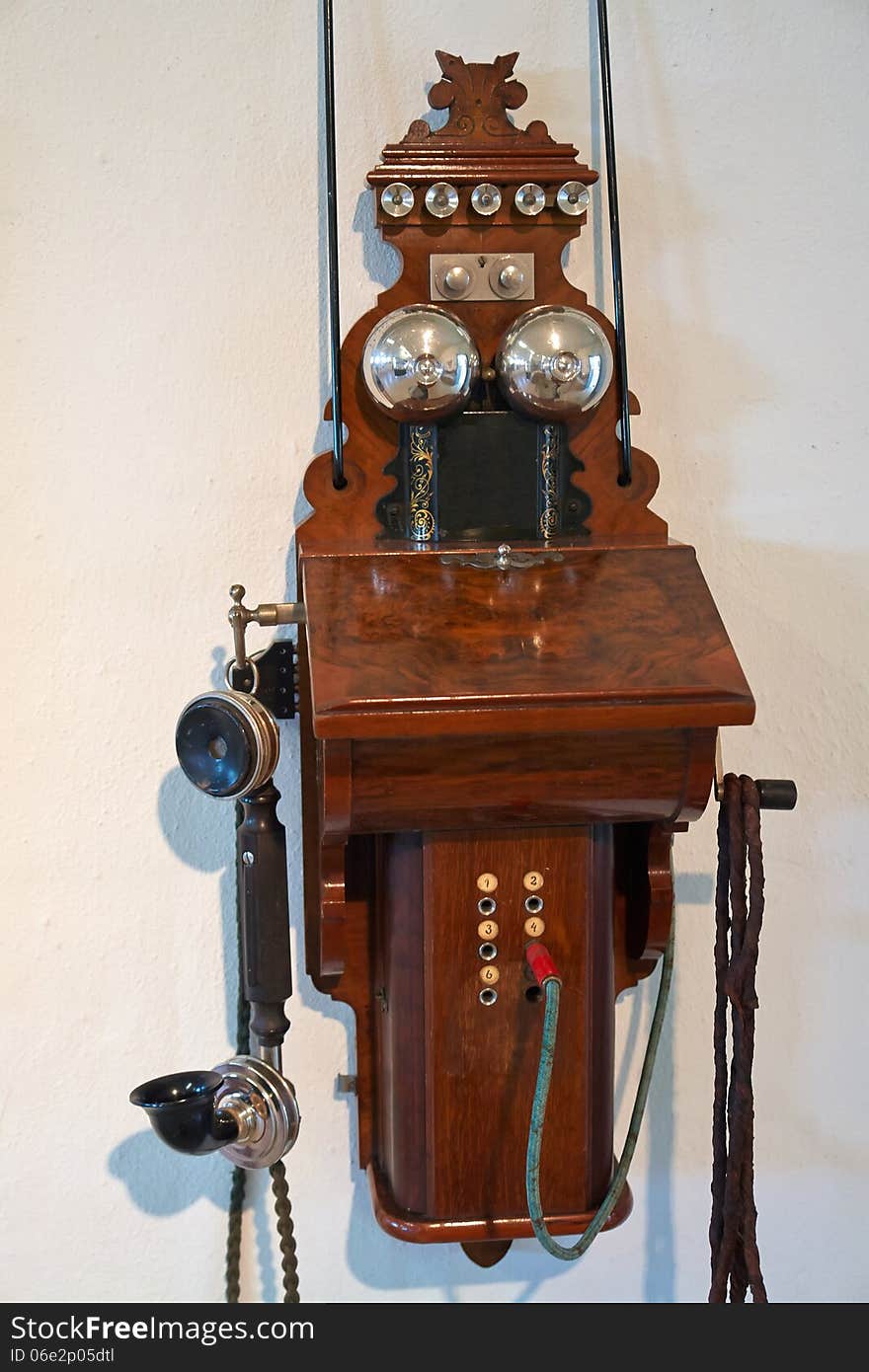 Antique old vintage wooden telephone hanged on a wall. Antique old vintage wooden telephone hanged on a wall