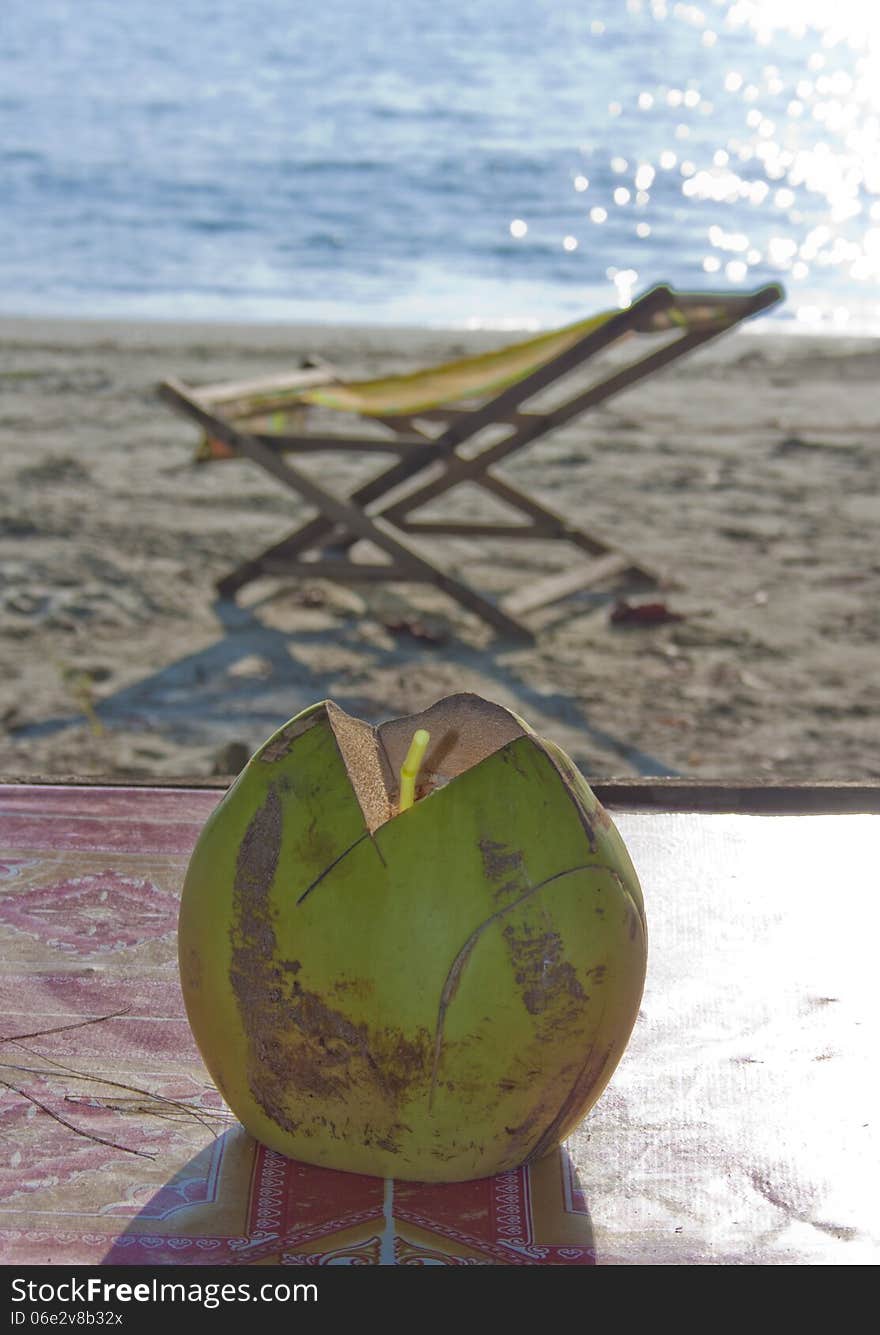 Coconut drink with strobe on the beach