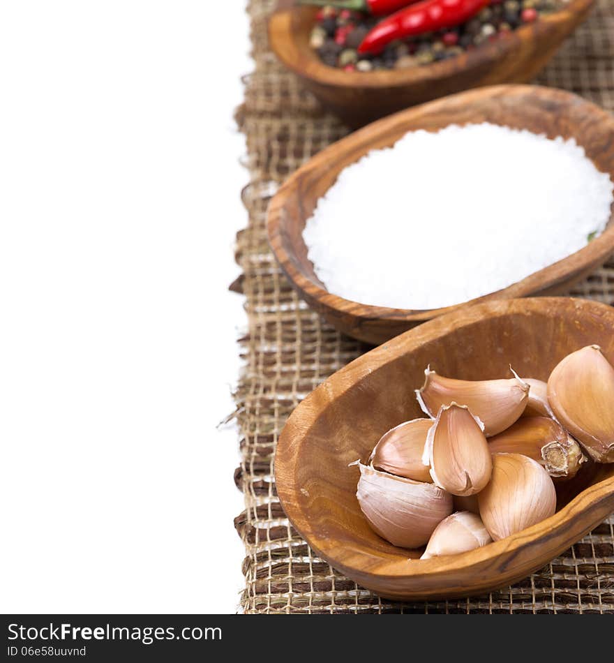 Cloves of garlic and sea salt in a bowls, isolated