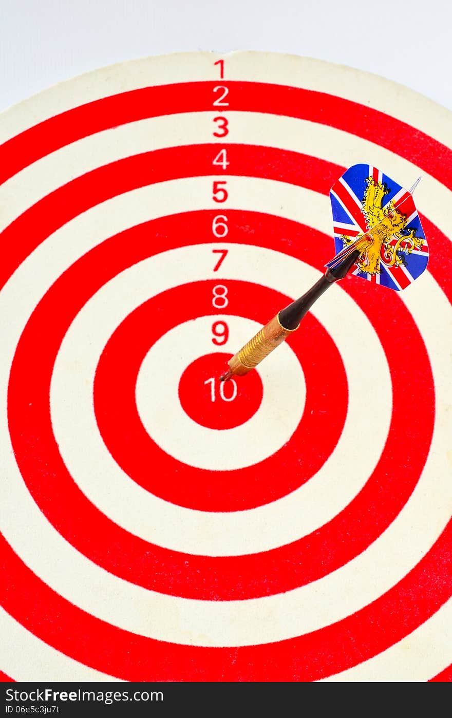 One dart ilustrated with variation of British flag in centre of red and white dart board over white background. One dart ilustrated with variation of British flag in centre of red and white dart board over white background