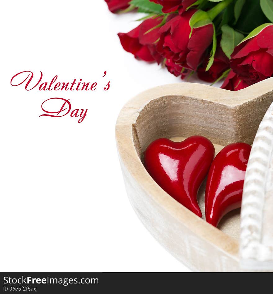 Red heart in a wooden box and roses, isolated on white