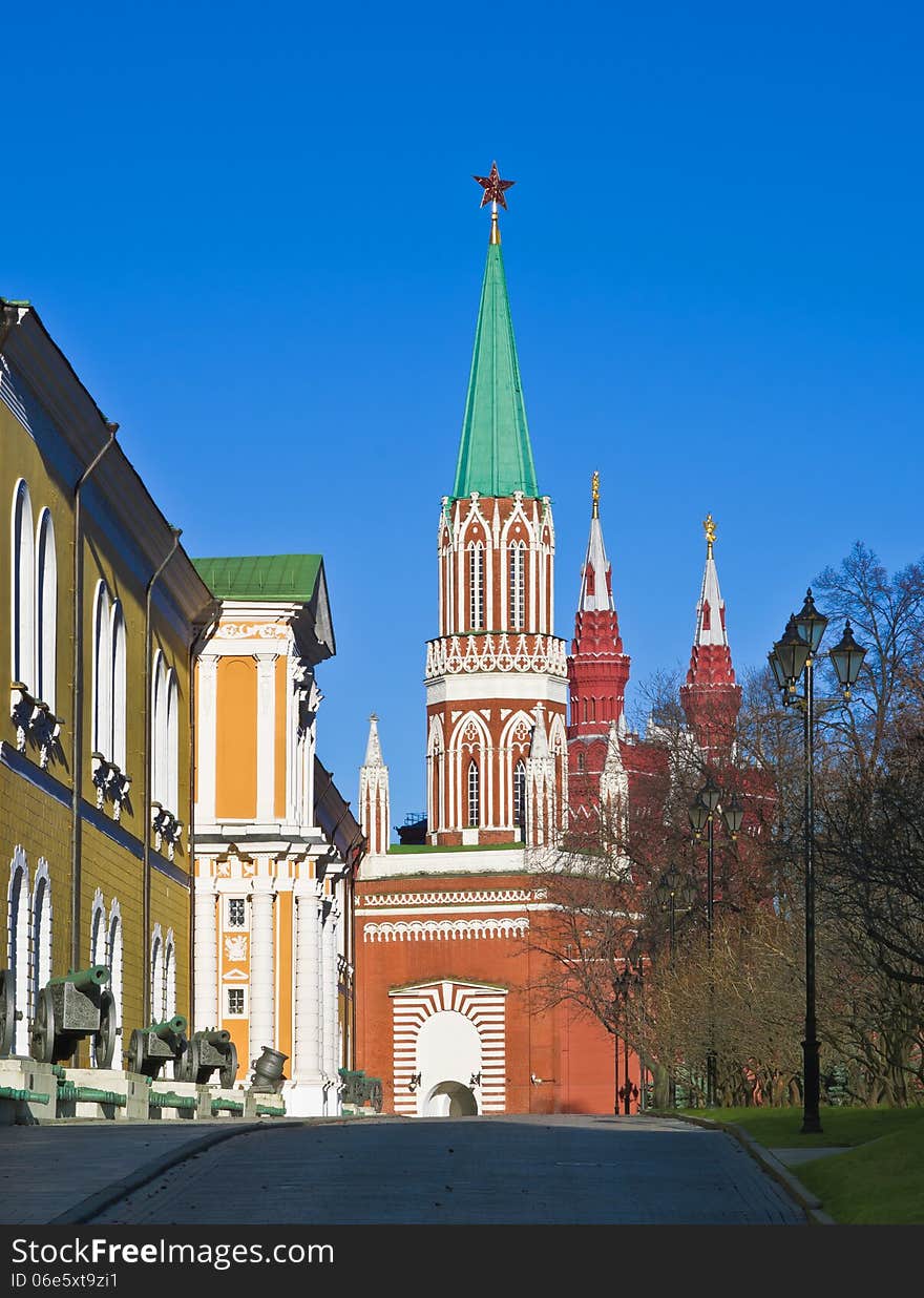 The Arsenal and the St. Nicholas (Nikolskaya) Tower in Moscow Kremlin. Towers of State Historical Museum in the background. Moscow, Russia. The Arsenal and the St. Nicholas (Nikolskaya) Tower in Moscow Kremlin. Towers of State Historical Museum in the background. Moscow, Russia