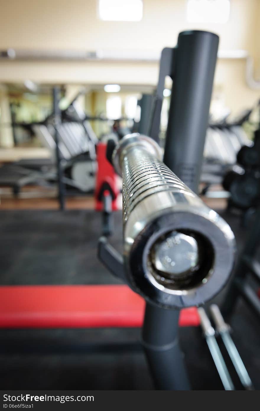 Empty barbell bar waiting to workout, shallow DOF