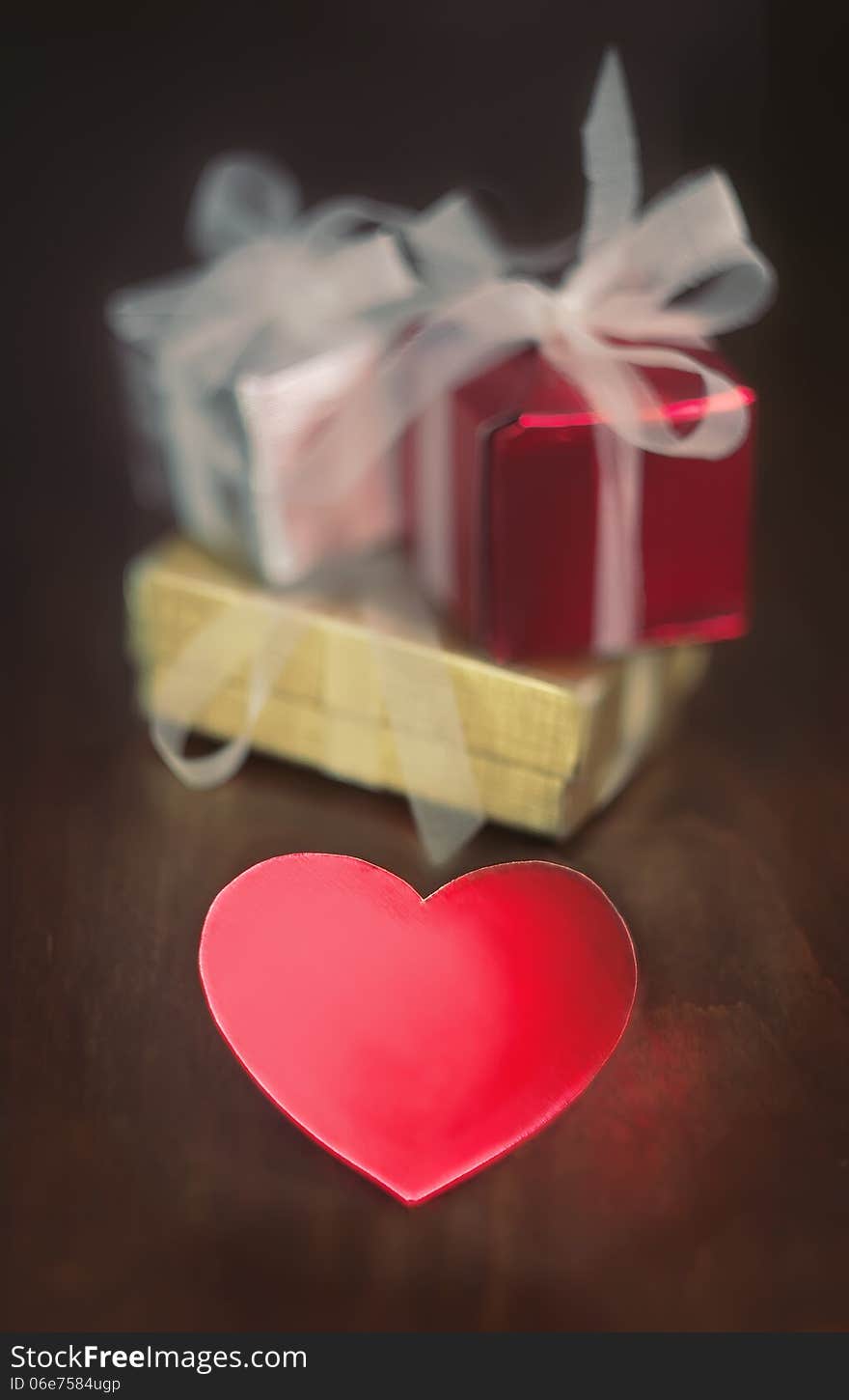 Decorative gift boxes and heart shaped object on wooden table. Decorative gift boxes and heart shaped object on wooden table