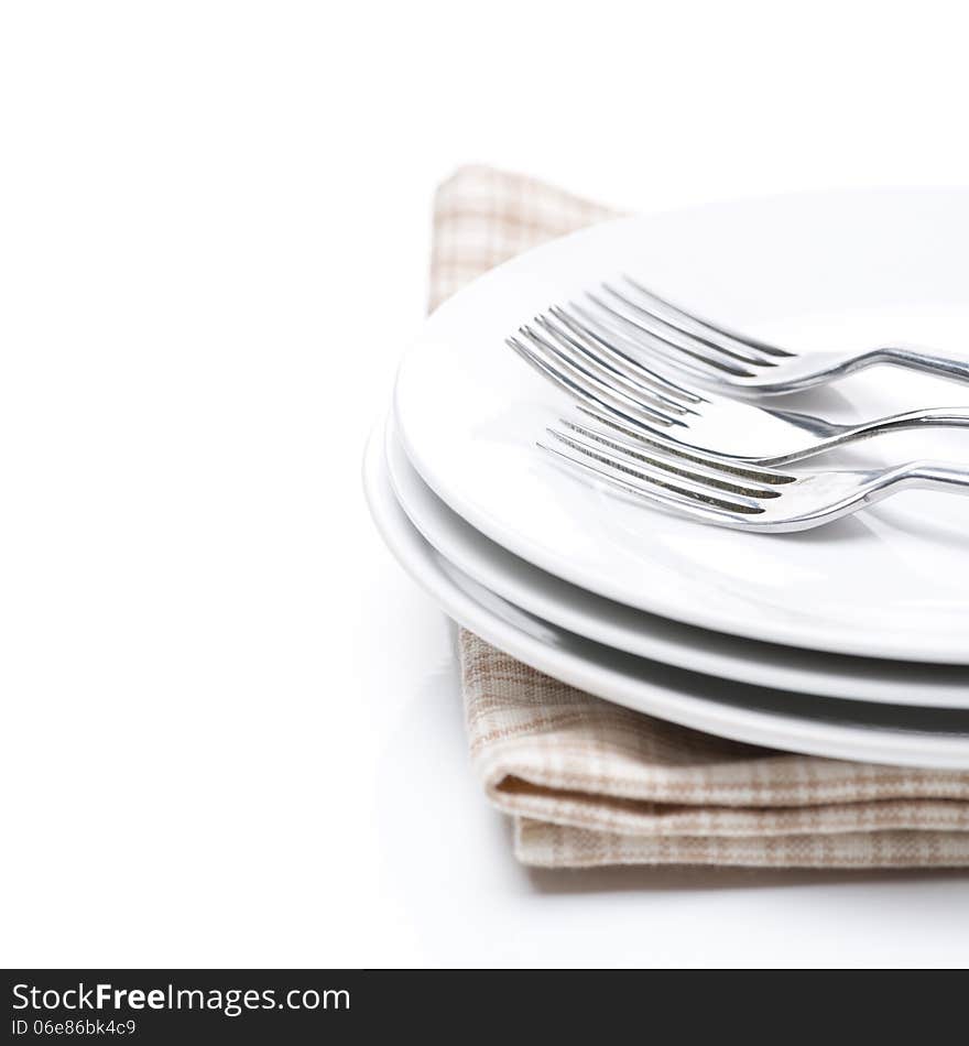 Tableware for dinner - plates and forks, isolated on white