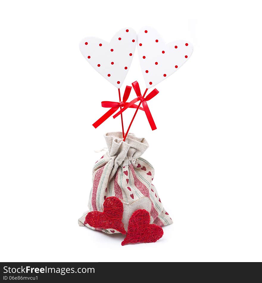 Two wooden hearts on a stick in the sack, isolated