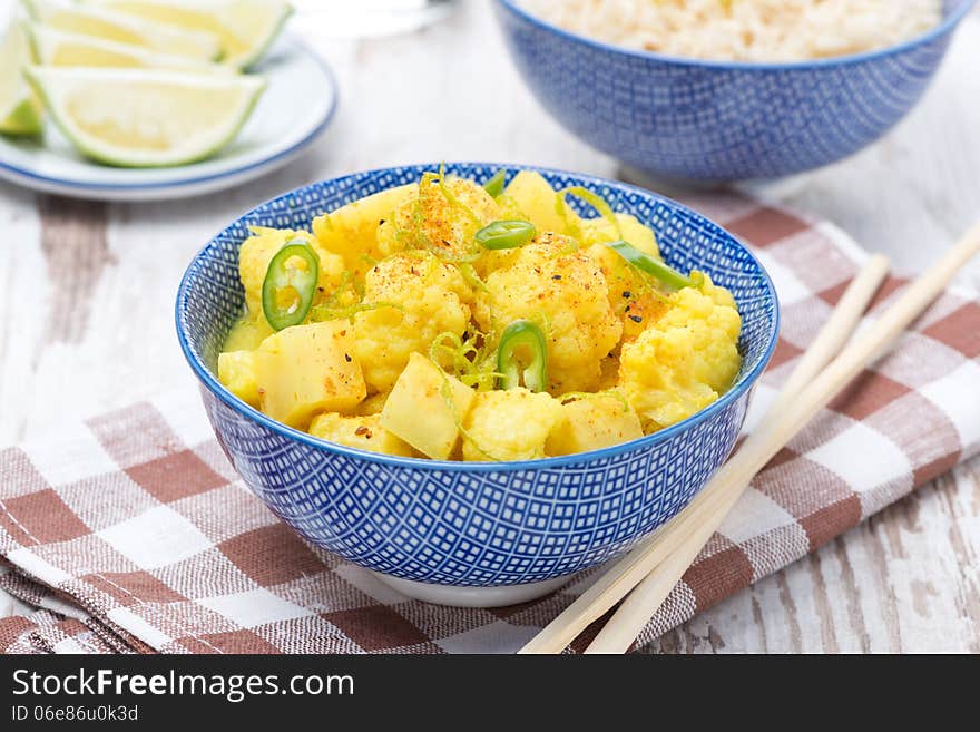 Vegetable curry with lime in a bowl, close-up