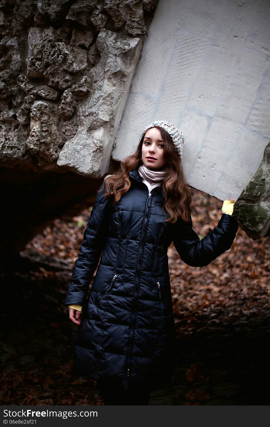 Beautiful Woman In Black Coat With Stone Bridge