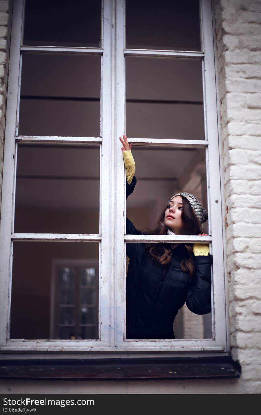 Beautiful Woman Looking Through The Window And Fearing Of Something