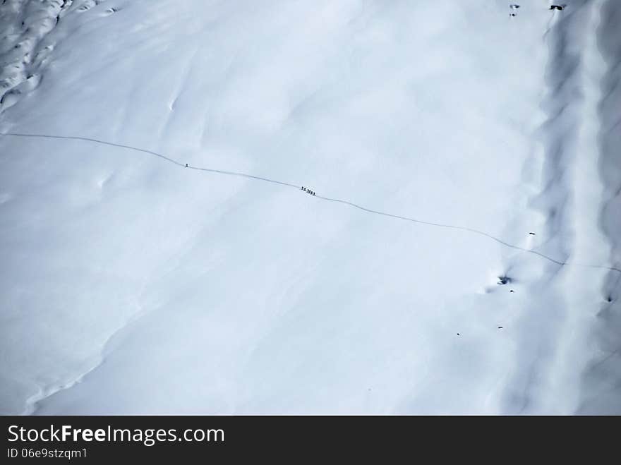 A group of tourists climbs mountains glaciert, Switzerland.