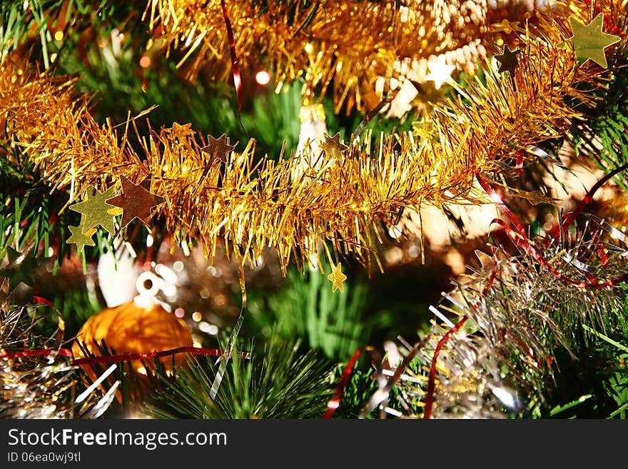 Detail of golden christmas chain on a tree branch. Detail of golden christmas chain on a tree branch