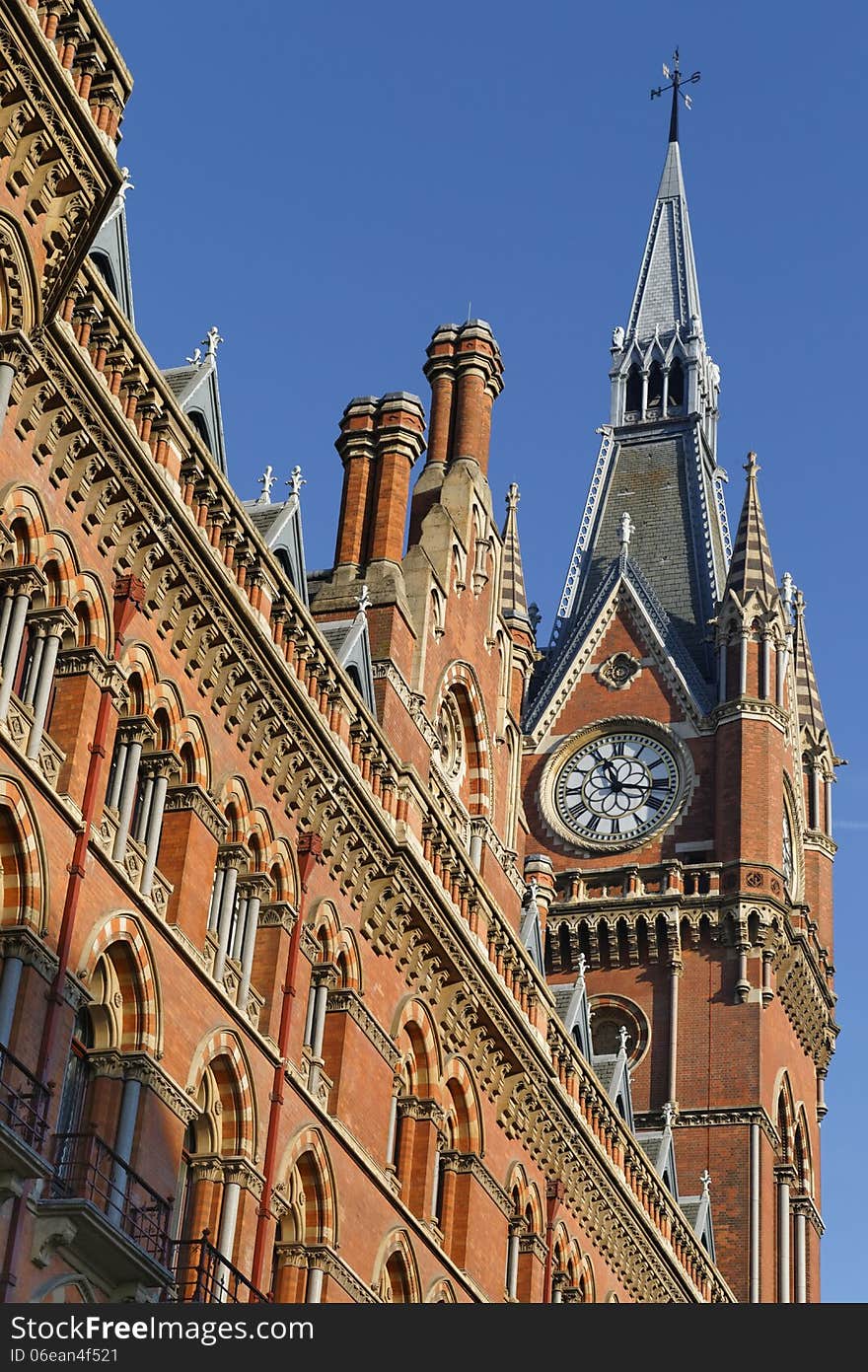 Image taken of a victorian clock tower against blue sky, kings cross, London, England