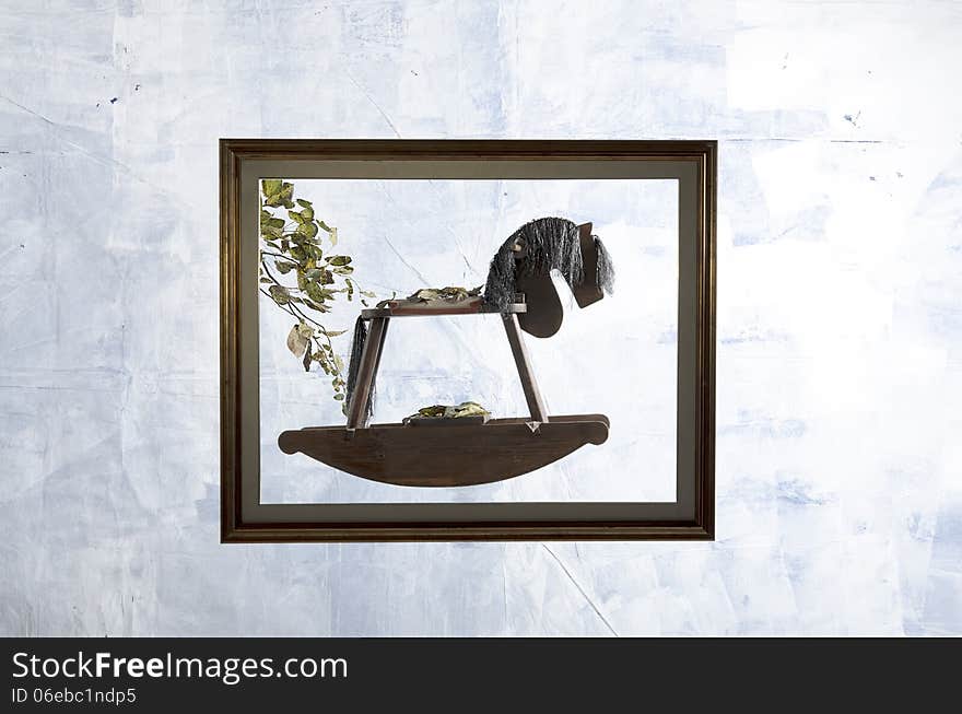 Rocking horse in a frame on the white background stop time in the autumn season. Rocking horse in a frame on the white background stop time in the autumn season.