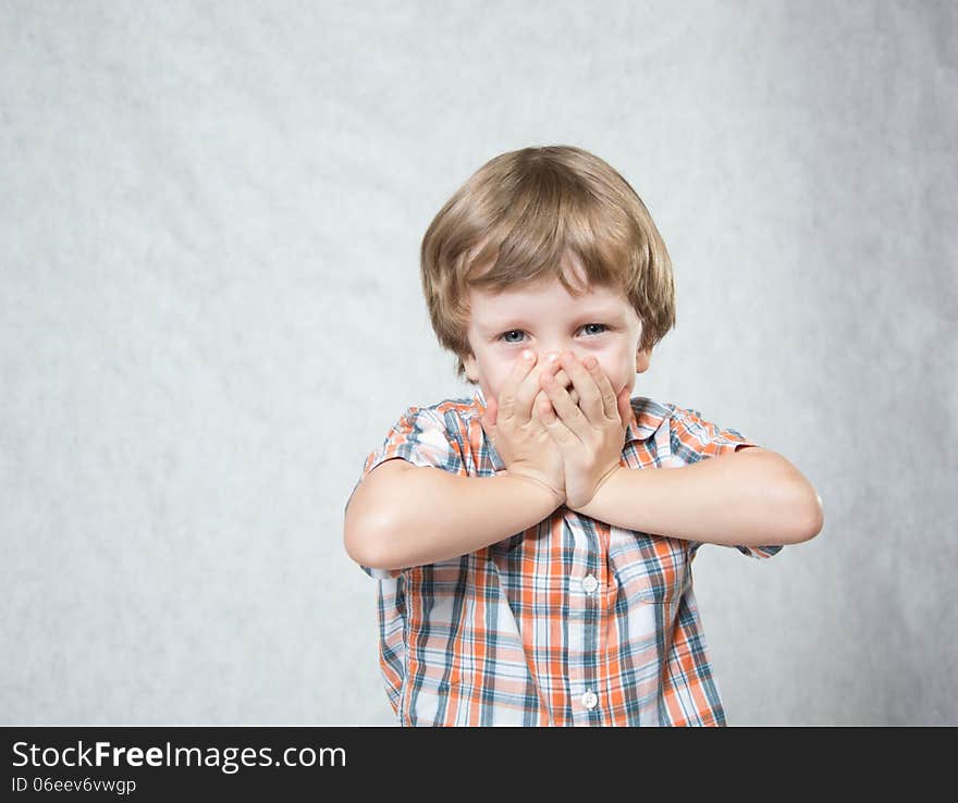 Blond boy shows both hands okay and laughs. Blond boy shows both hands okay and laughs