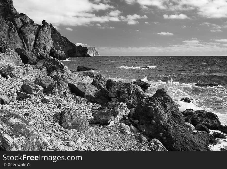 Ukraine, peninsula of Crimea, Sea coast on the Black Sea, large and small pebbles, large boulders, sea waves. Ukraine, peninsula of Crimea, Sea coast on the Black Sea, large and small pebbles, large boulders, sea waves