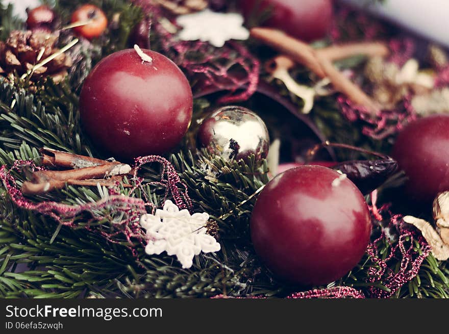 Close up on Christmas candles and ribbons on pine garland decoration. Close up on Christmas candles and ribbons on pine garland decoration