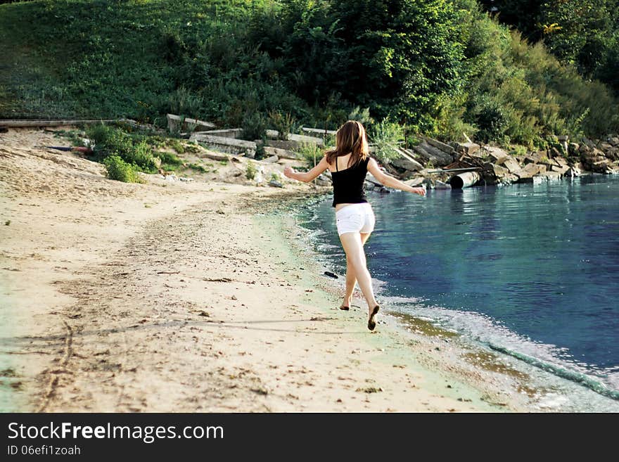 Happy Woman Running Jumping Trough The Beach