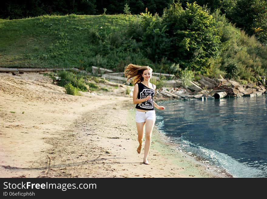 Happy woman jumping trough the beach. Happy woman jumping trough the beach