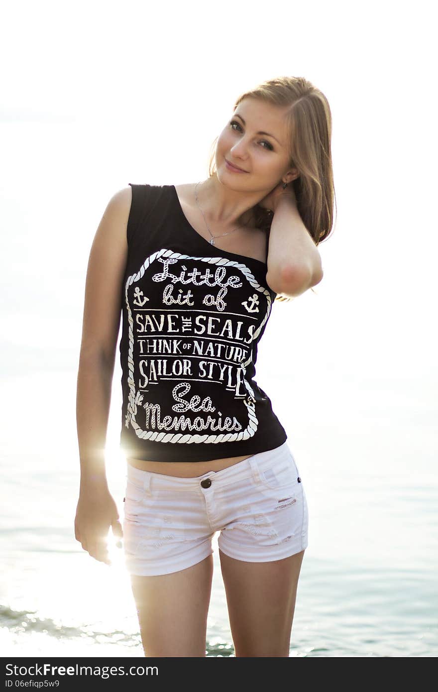 Happy Woman Standing On The Sunny Sea Beach