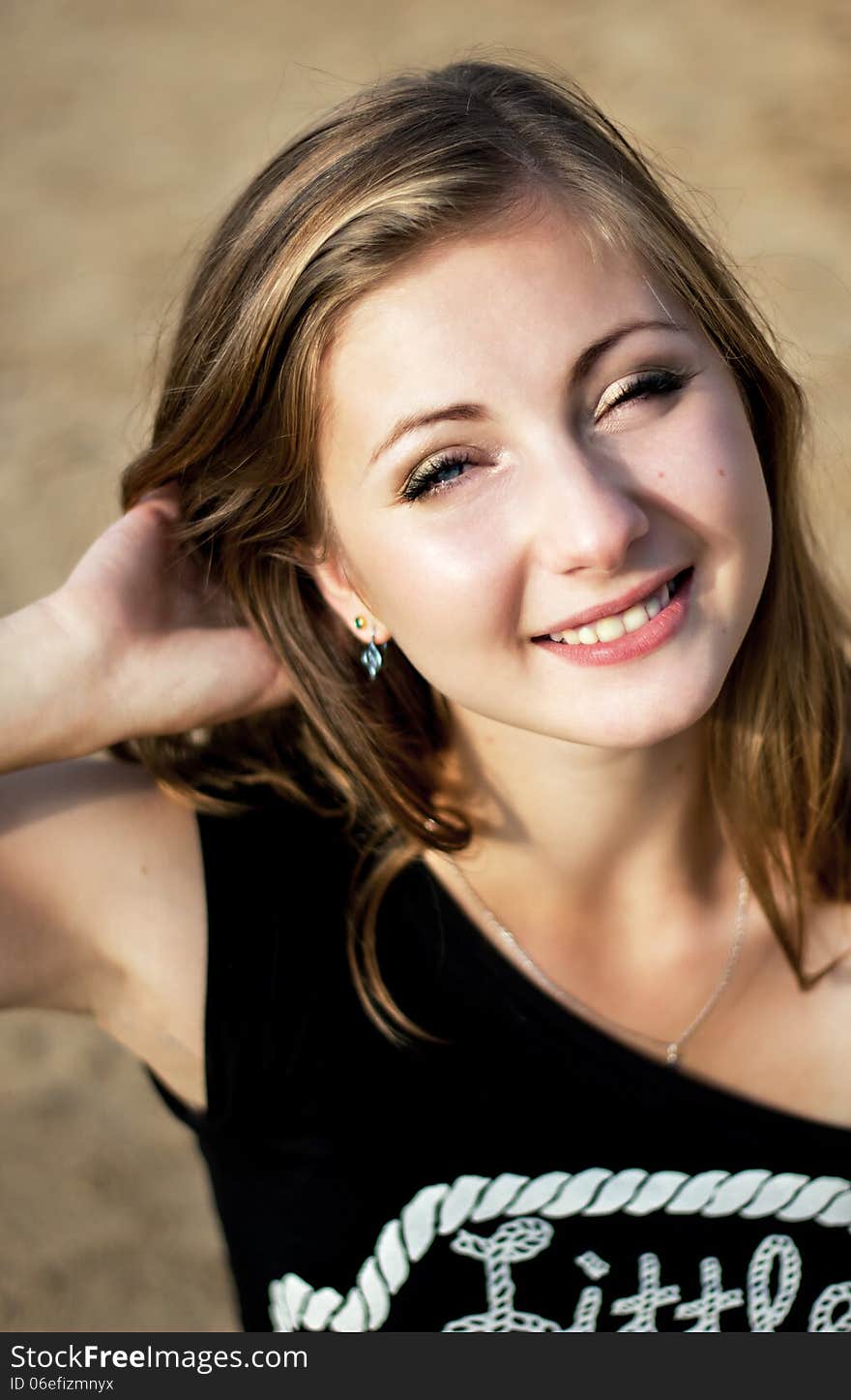 Beauty face of happy smiling woman in yellow sunny beach